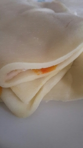 Khapsey dough, with one side colored orange 